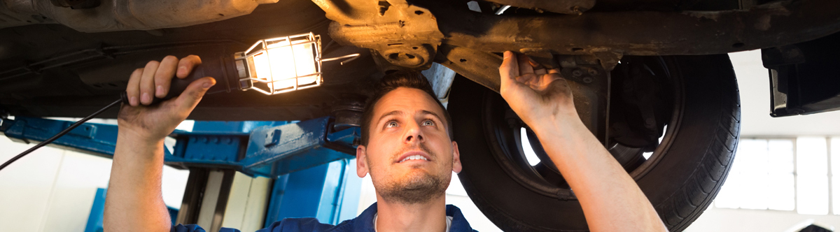 Mechanics checking and servicing a vehicle - Car Servicing Kirkby