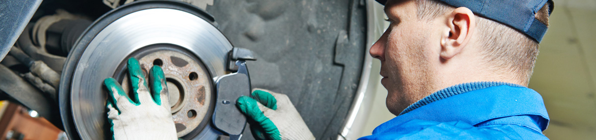 Mechanic repairing a vehicles brake discs - Car Repairs Kirkby
